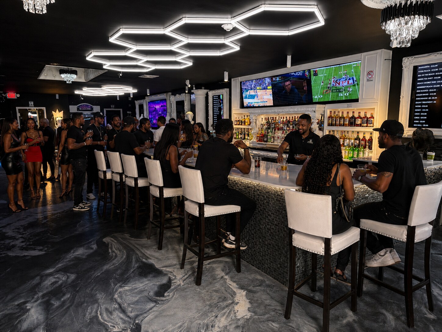 Guests gathered around the illuminated full-service bar at Acruz
