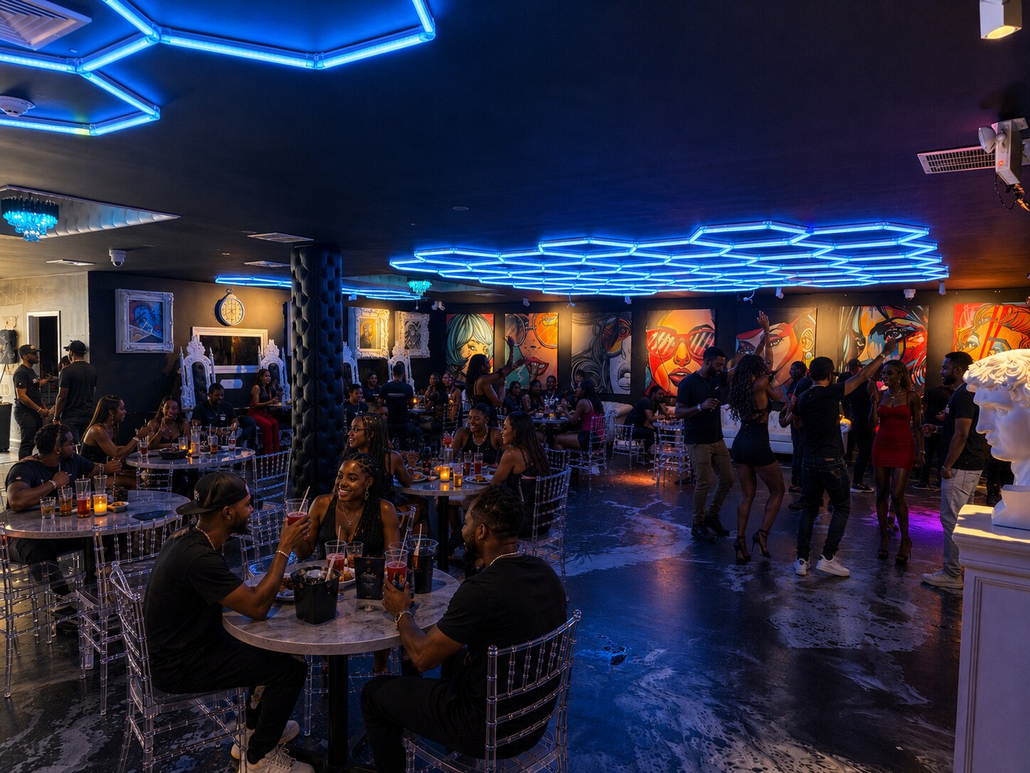 Guests dining, socializing, and dancing under blue lights at Acruz